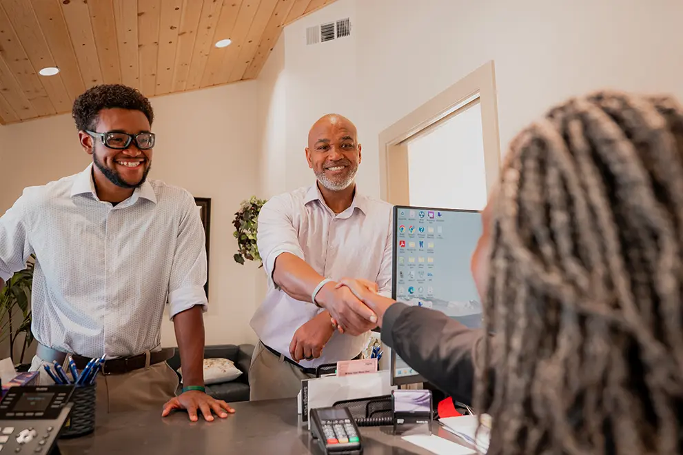 Patients speaking with the front office administrator